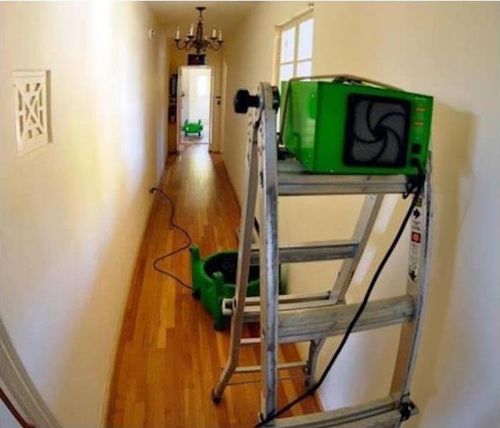 SERVPRO drying equipment placed in water damage hallway